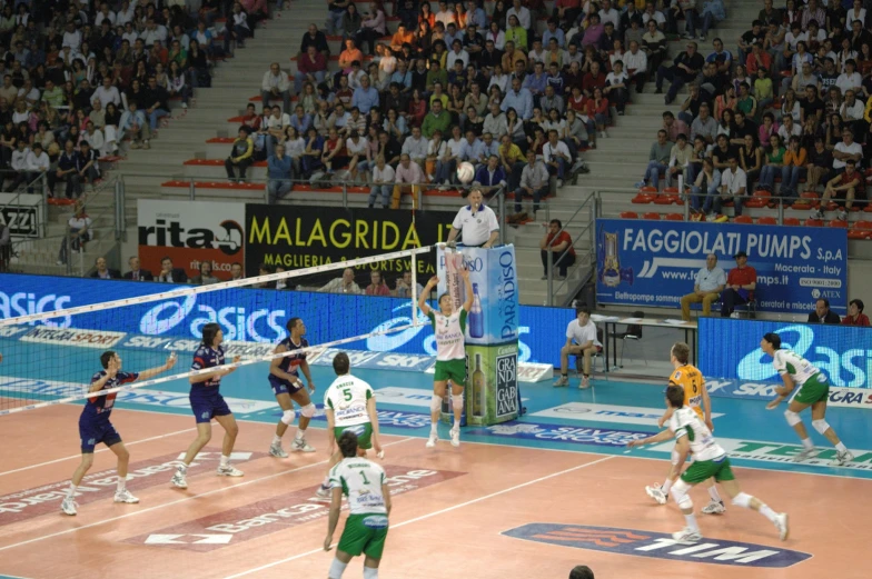 group of men playing a game of volleyball