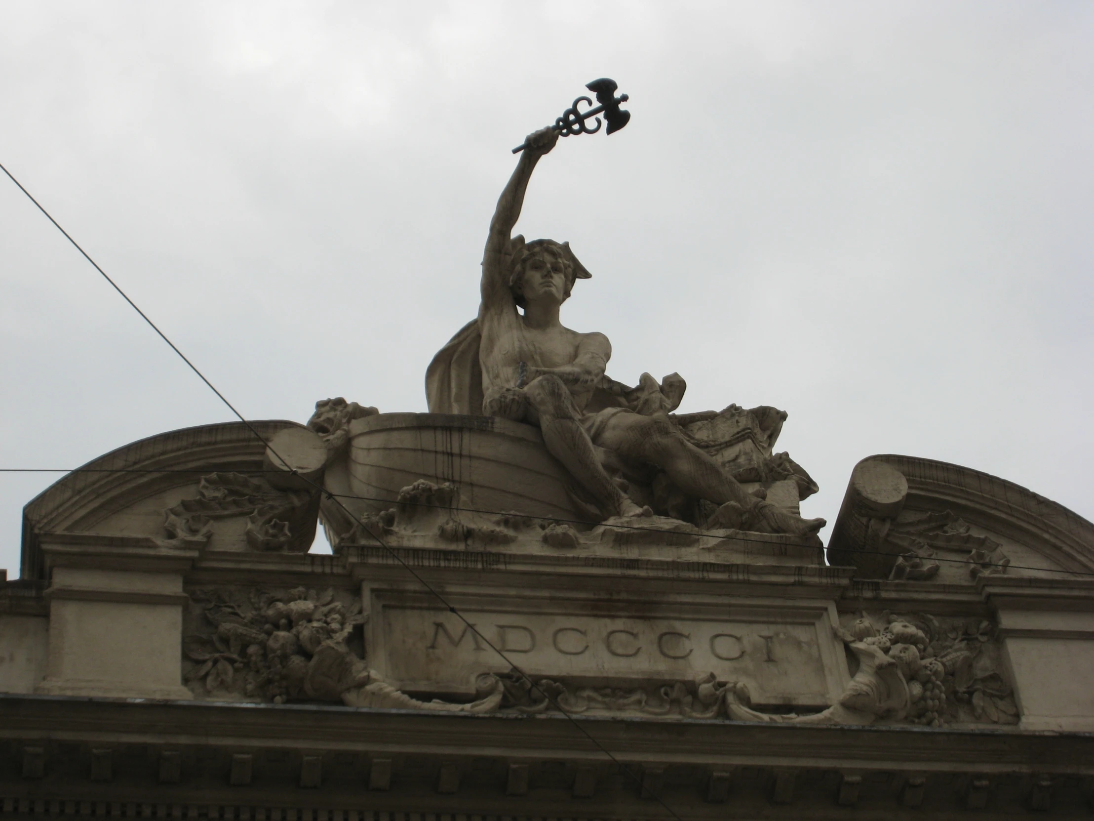 the statue of a woman is holding up a light