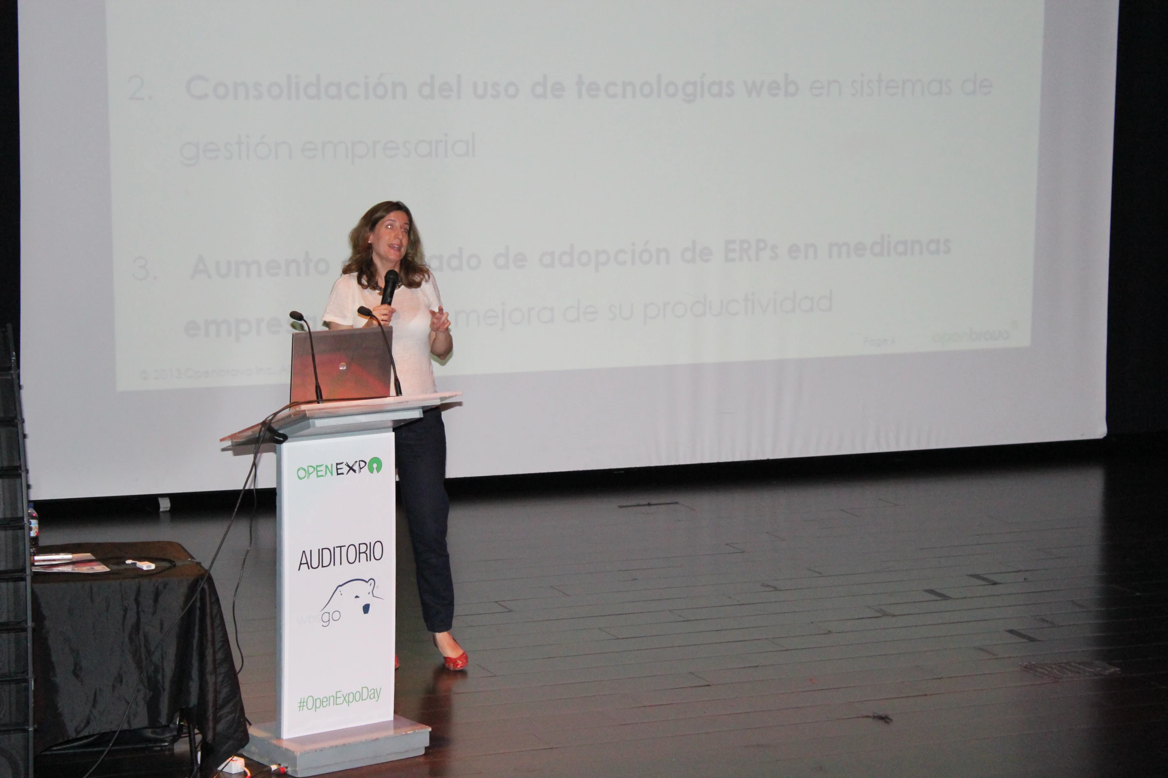 a woman is giving a speech on stage