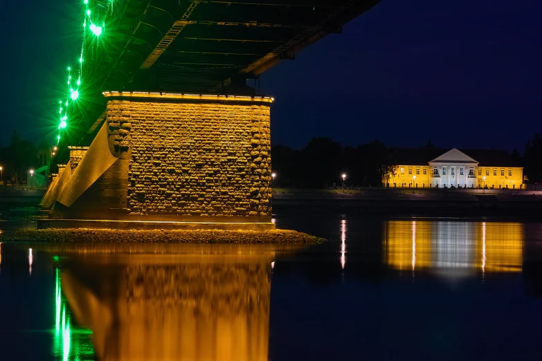 a bridge lit up with bright lights over water