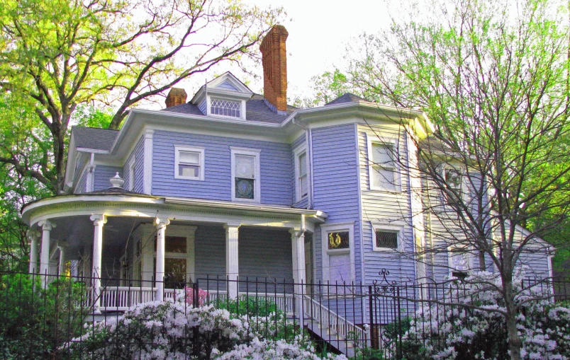 a blue two story home with white trim around it