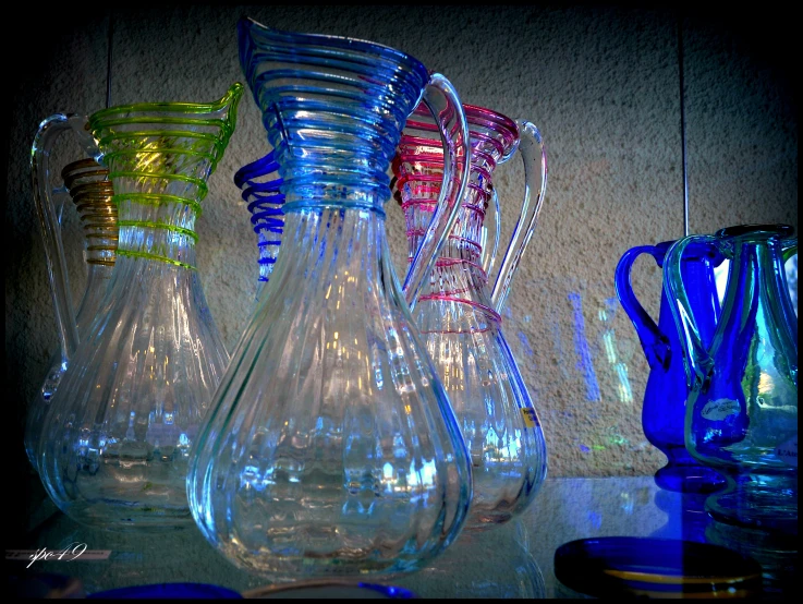 a variety of vases in the shape of a pitcher