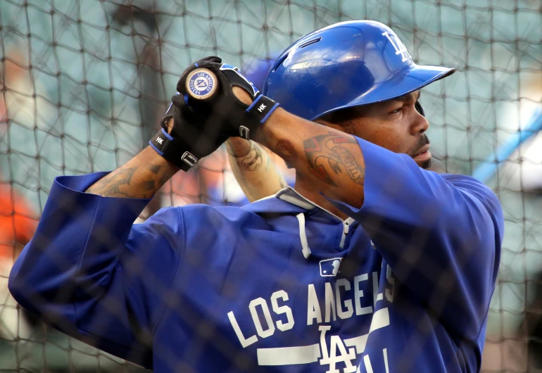 a baseball player is holding a ball in his hands