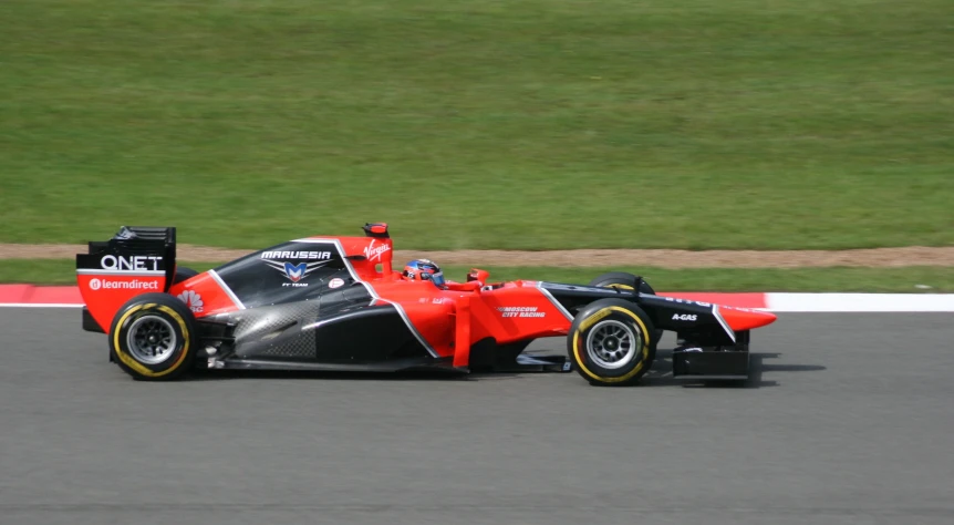 an orange race car with the number 70 driving