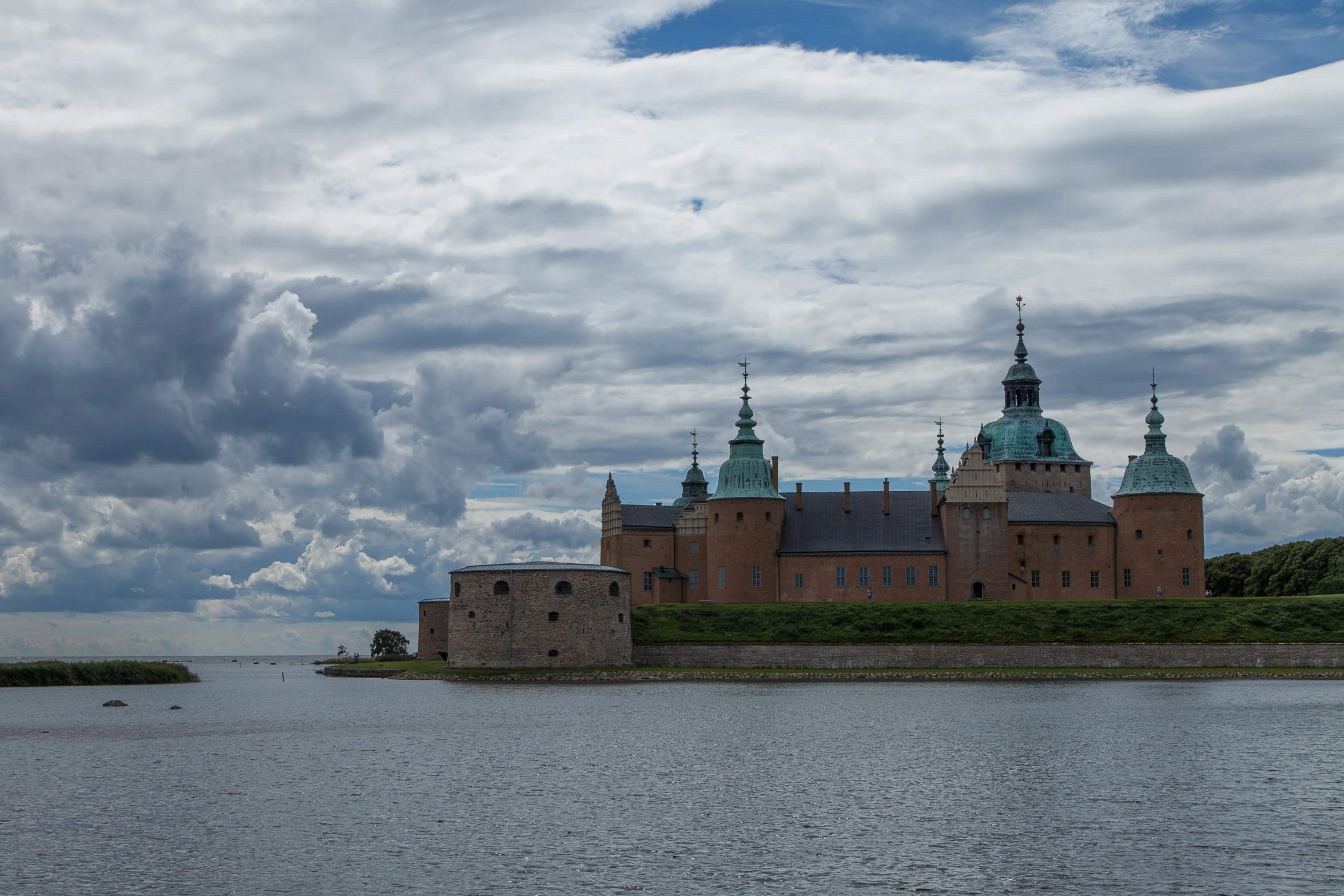 a large brick building near a body of water