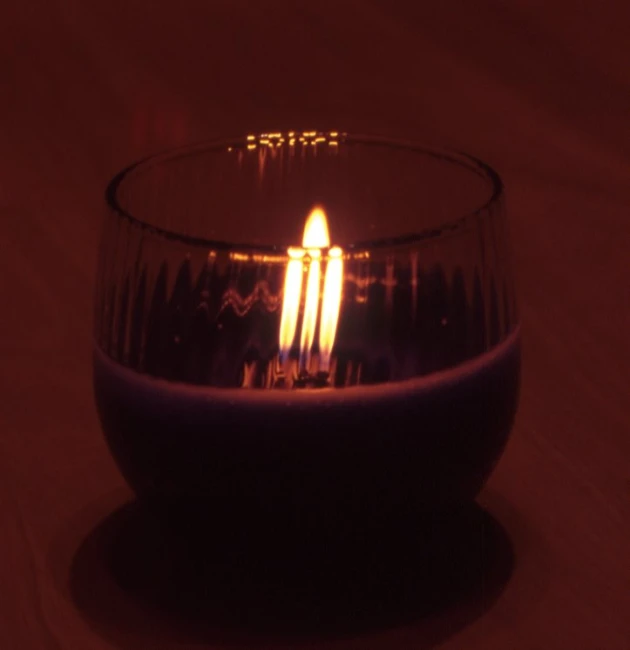 the candle is lit by the glass on the table