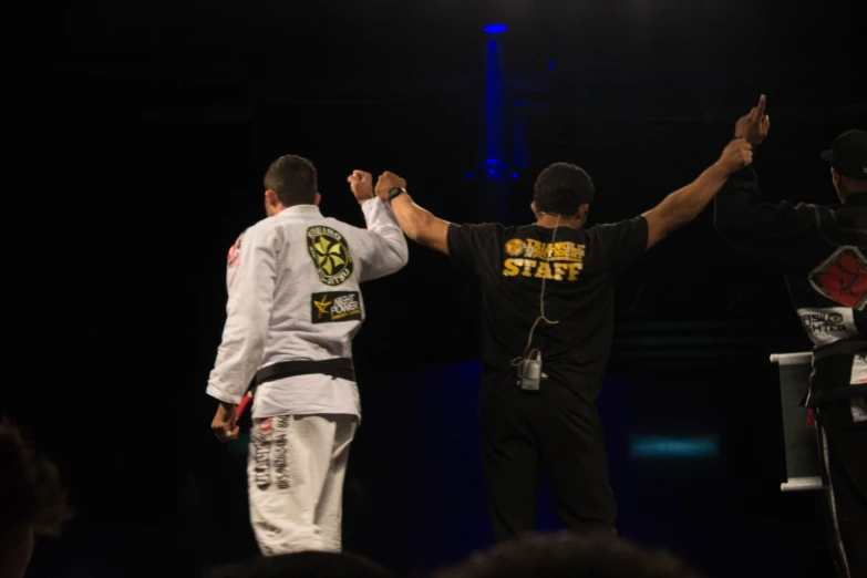 two men high five each other on stage