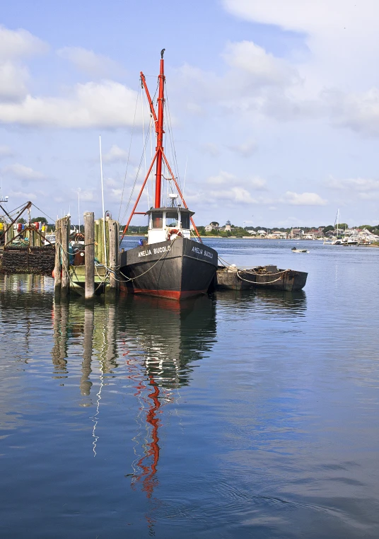 the large boat is sitting in the water next to the shore