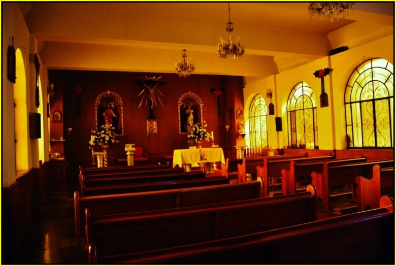 the church has two rows of pews with floral arrangements