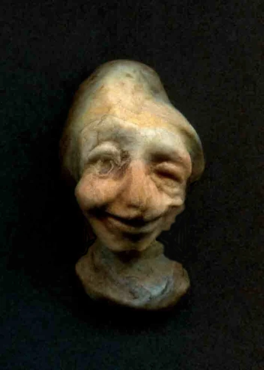 an old creepy mask that is being displayed