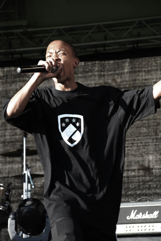 a man with an army flag on his shirt singing