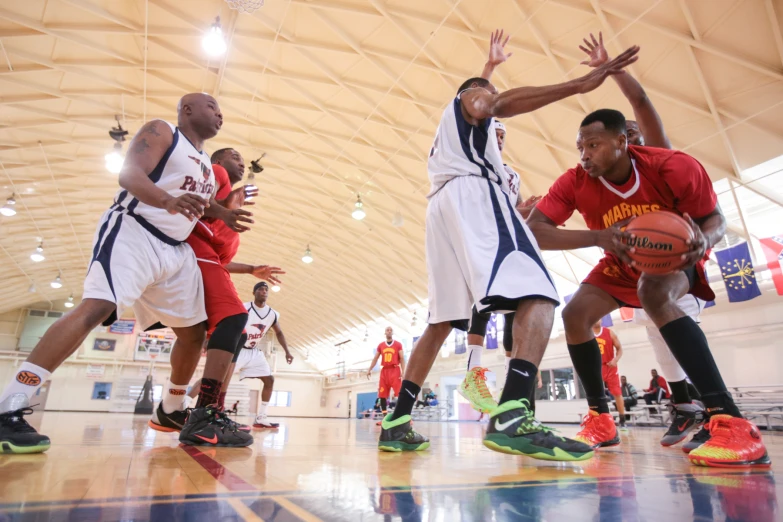 several basketball players on the court in a gym