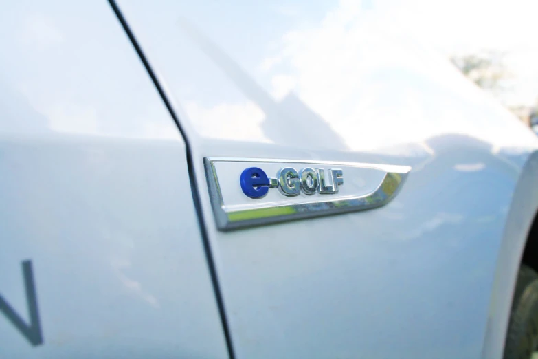 an emblem on the side of a blue sports car