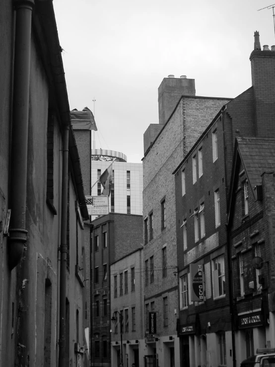 an old city street with a sign in the distance