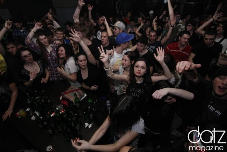 a crowd is having their po taken in front of an audience at a party