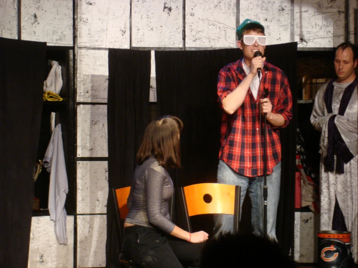 a man standing at a podium while talking to a woman