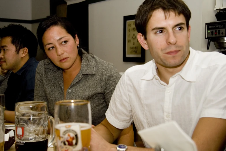 people sitting around a bar with beers and beverages