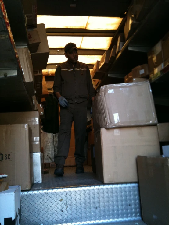 a person standing by some boxes and shelves