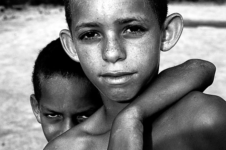 there is two children standing together on the beach