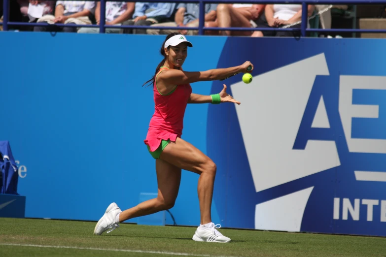 a female tennis player in red is playing tennis