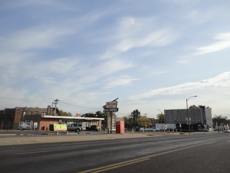 a sign for a gas station near the street