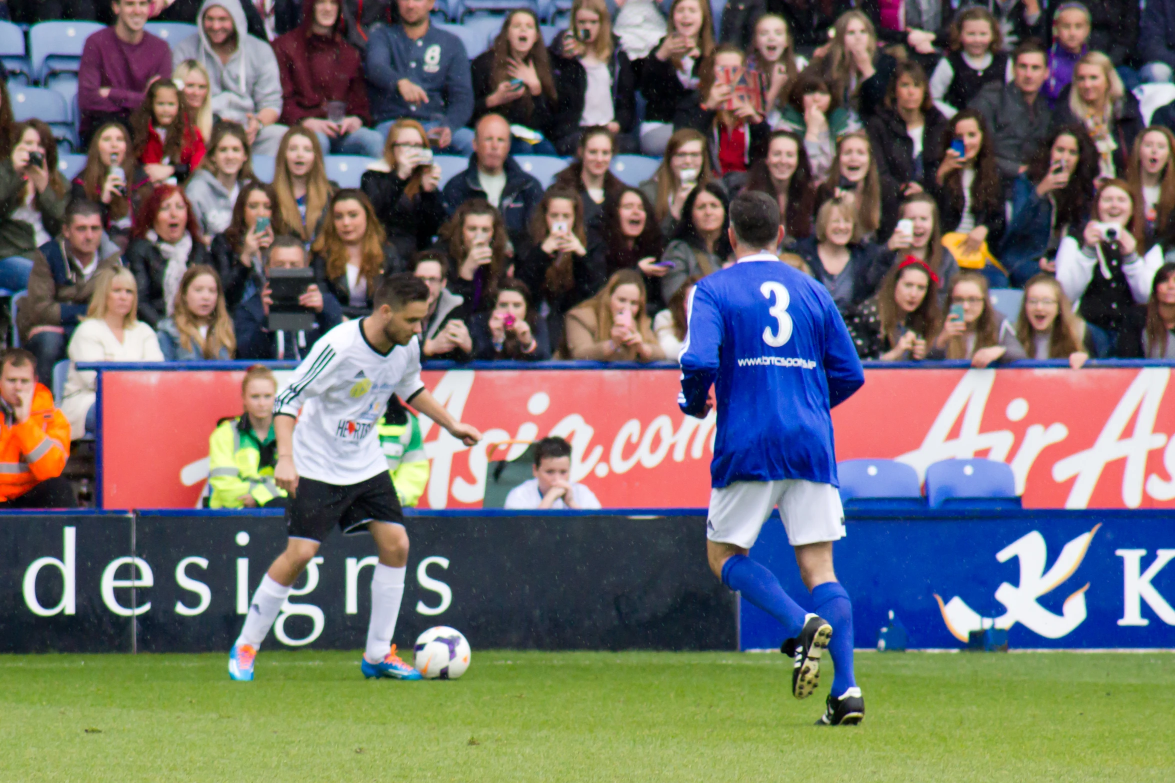 a group of people that are on a soccer field