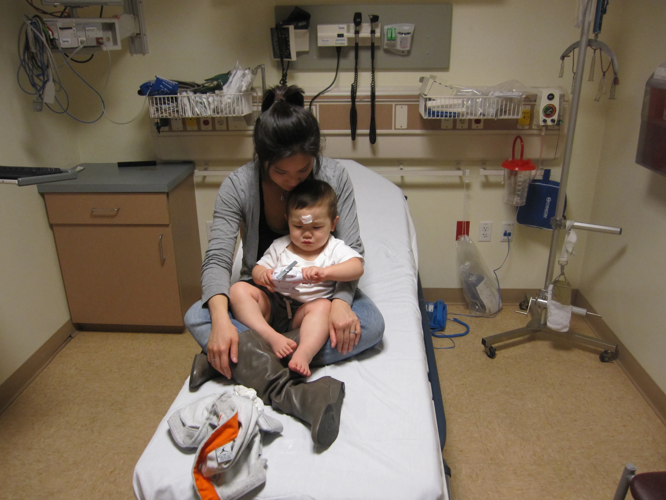 a woman in hospital with a child on a bed