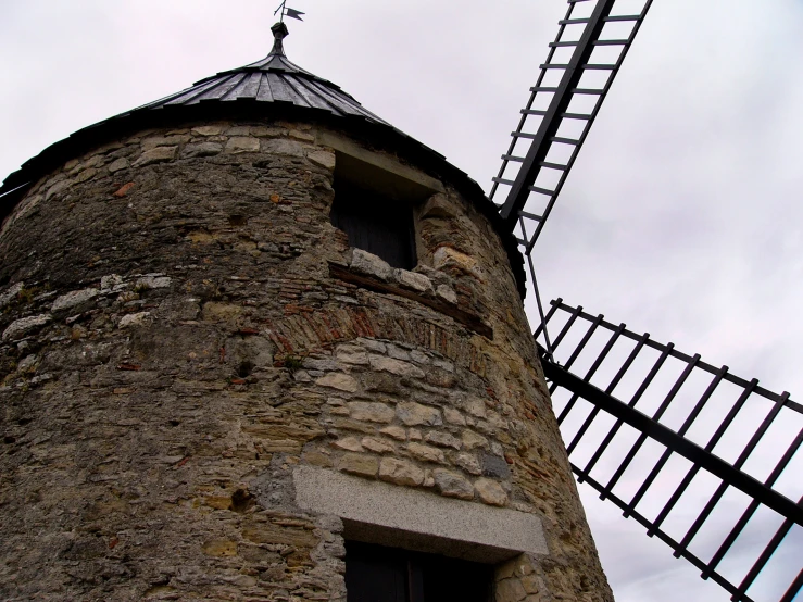 the tall tower has a metal roof on it