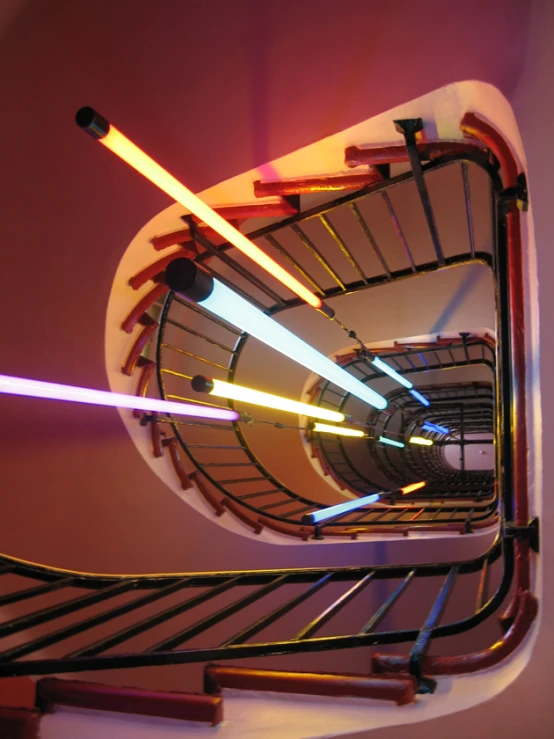 colorful lights being reflected on a spiral staircase