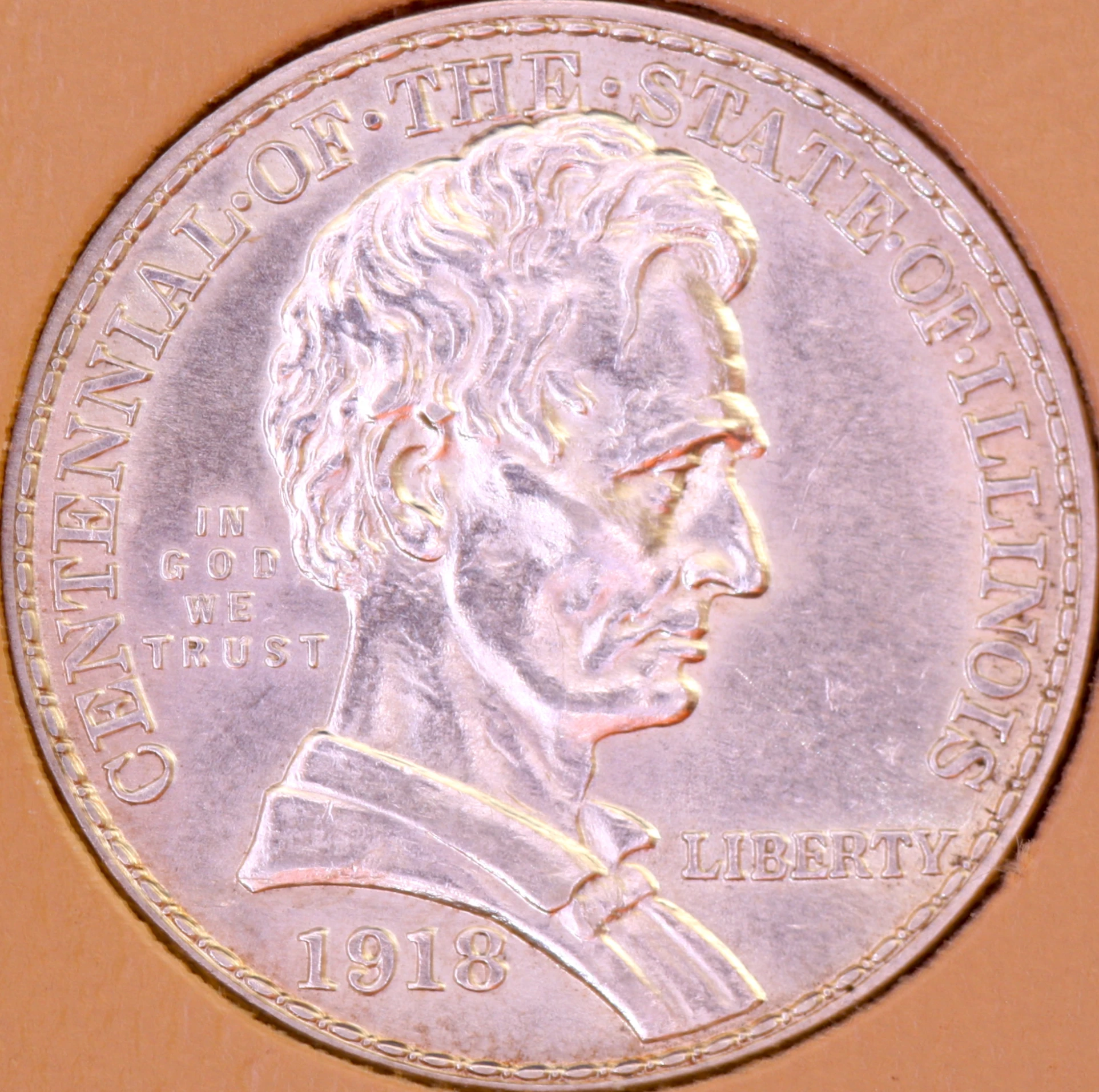 a silver coin that is on display