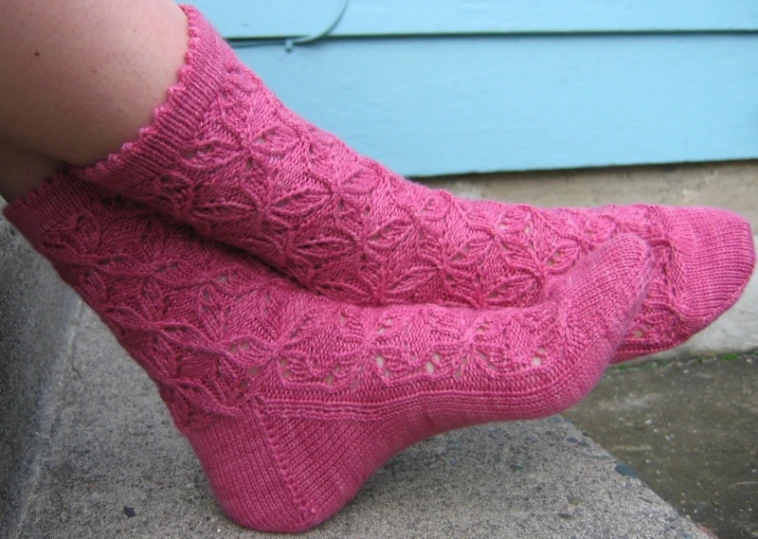 a person wearing pink socks and socks with lacy knits