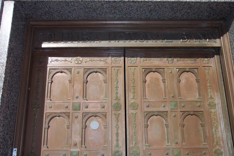 a close up of two brown doors with ornate carvings