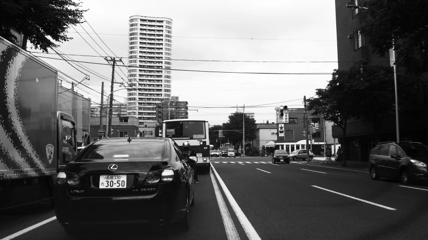 cars on a city street in a black and white po