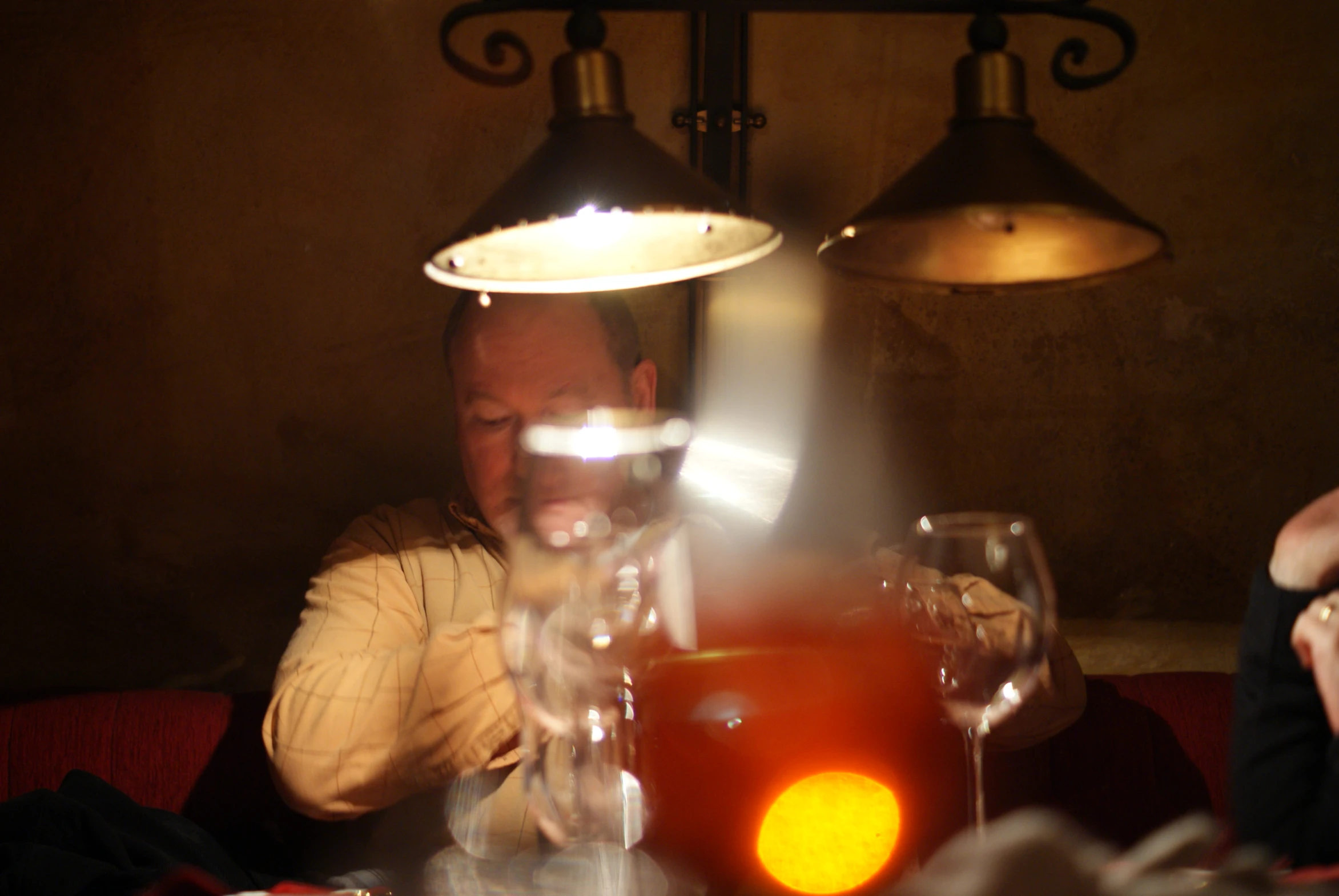 a person at a table having wine and some food