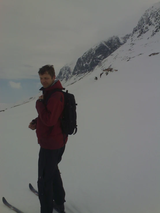 a skier smiles while standing on his skis