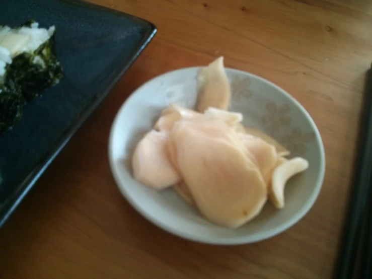 a plate with three ravioli slices in it, one half eaten