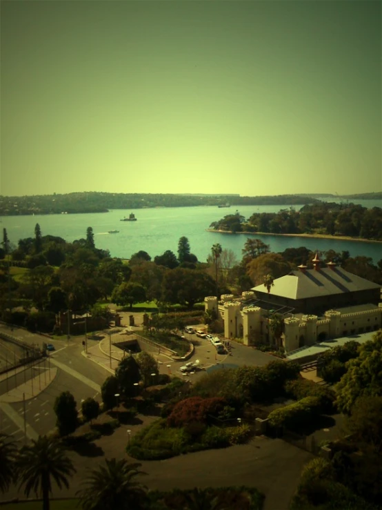 a city and lake in front of a forest filled with trees