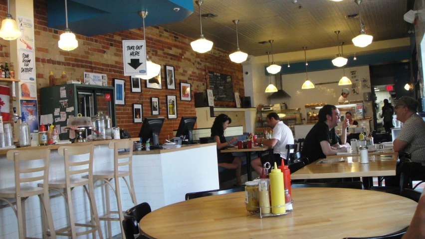 an indoor restaurant with tables and chairs