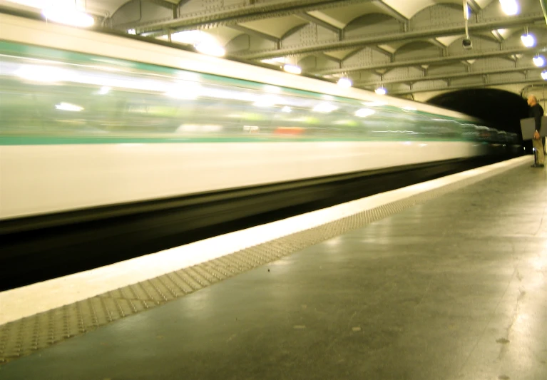 man waiting on the platform at the train station