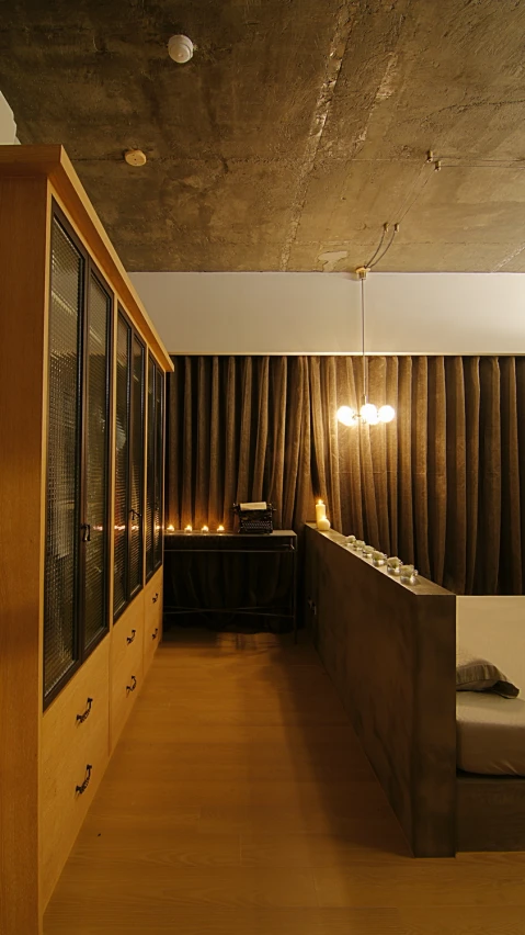 this hallway features wood flooring and an exposed ceiling