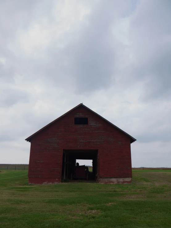 the barn is empty and looks out into the open field