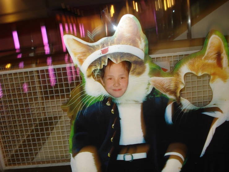 boy wearing cat costumes in front of fake background