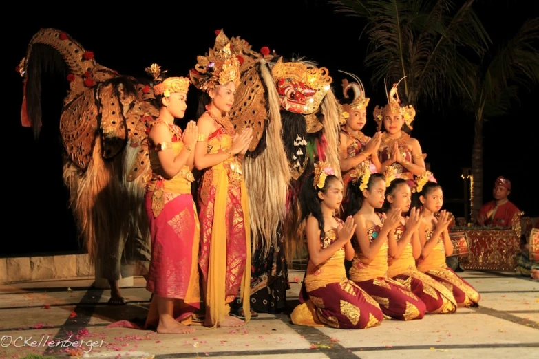 the men and women are dancing in traditional dress