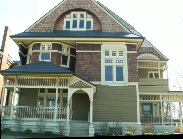 an ornate brown and tan building with two story windows