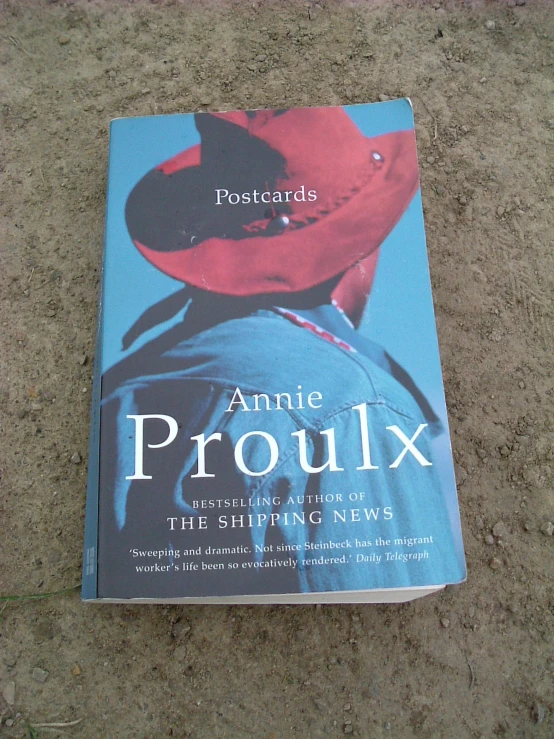 a book is laying on the floor with an image of a red hat and jacket