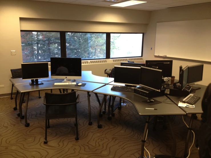 a room that has a bunch of desks on it