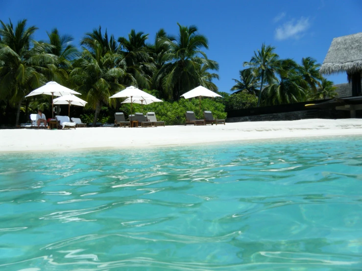 a beach with white sand and clear blue water