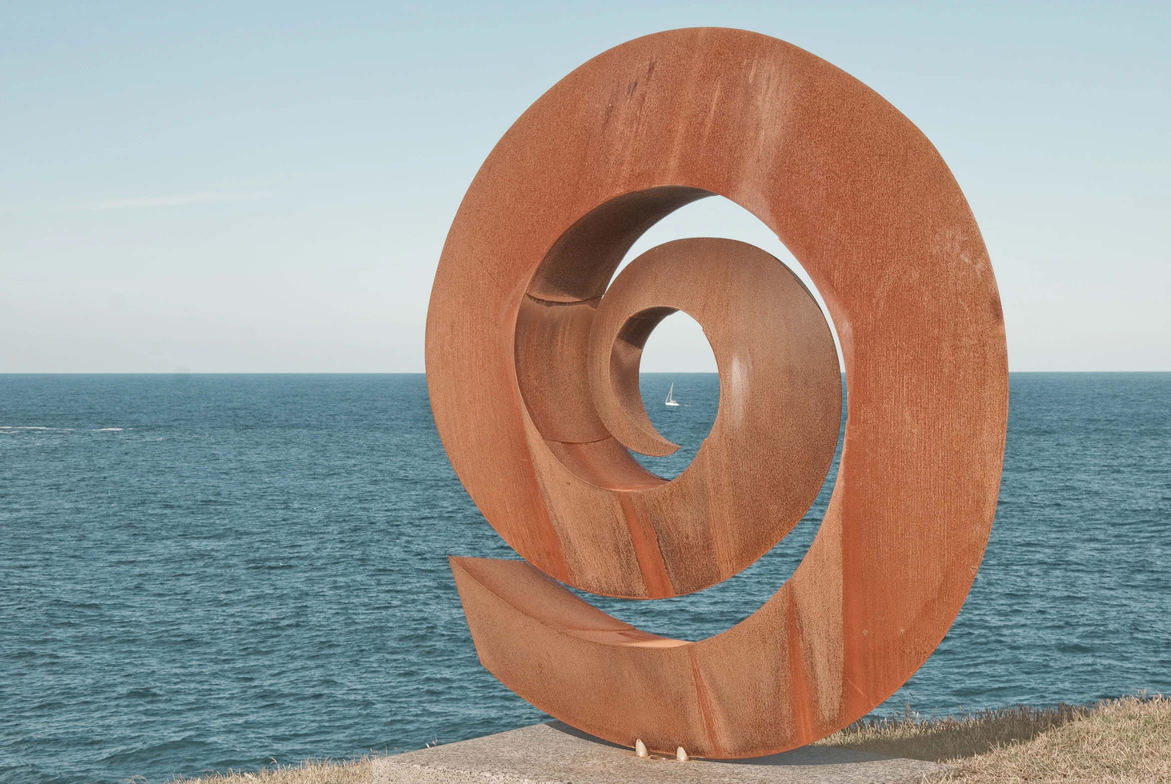 a sculpture in the middle of the ocean