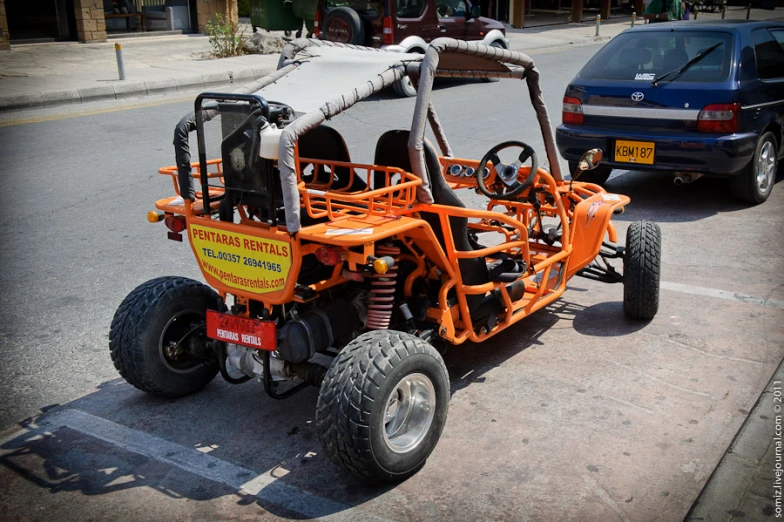 an orange cart parked on the side of the street