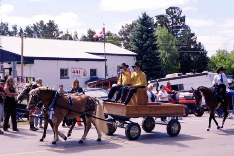 people are in the background on two horses pulling a cart